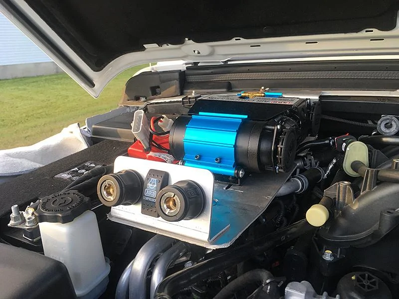 Jeep Gladiator Under the hood ARB compressor mount with remote air chuck/rocker switch/air filter relocation brackets. air-chucks-front
