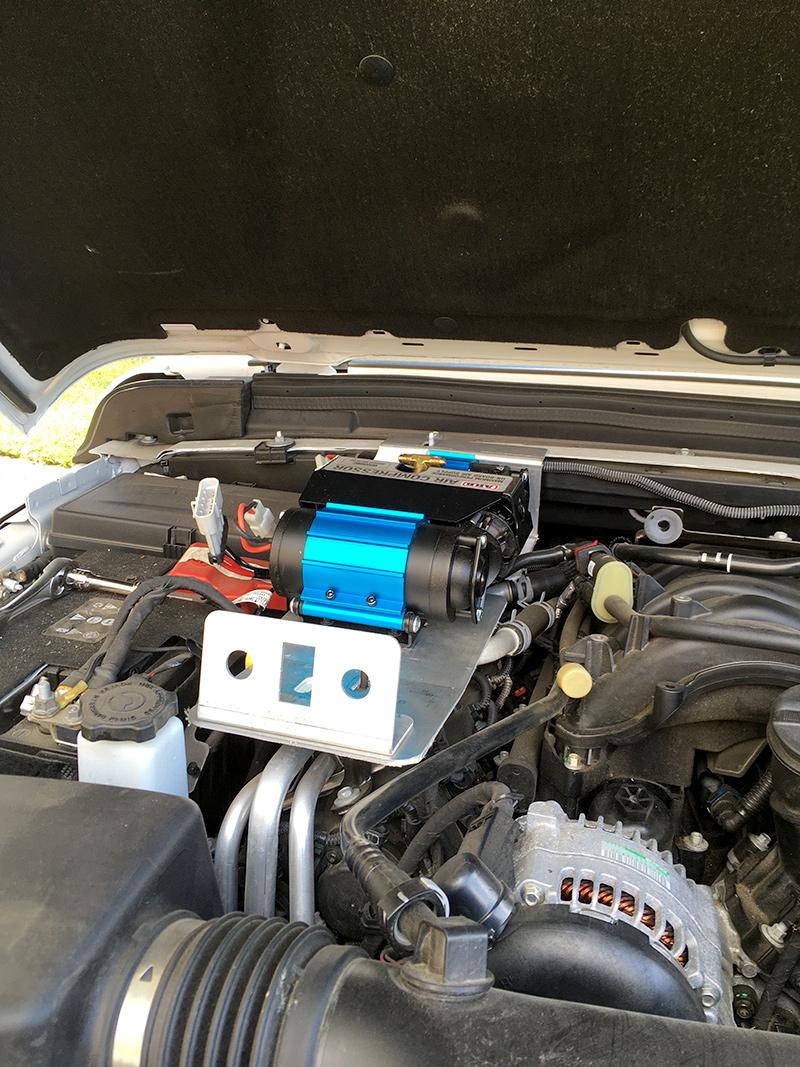 Jeep Gladiator Under the hood ARB compressor mount with remote air chuck/rocker switch/air filter relocation brackets. JL-mounted