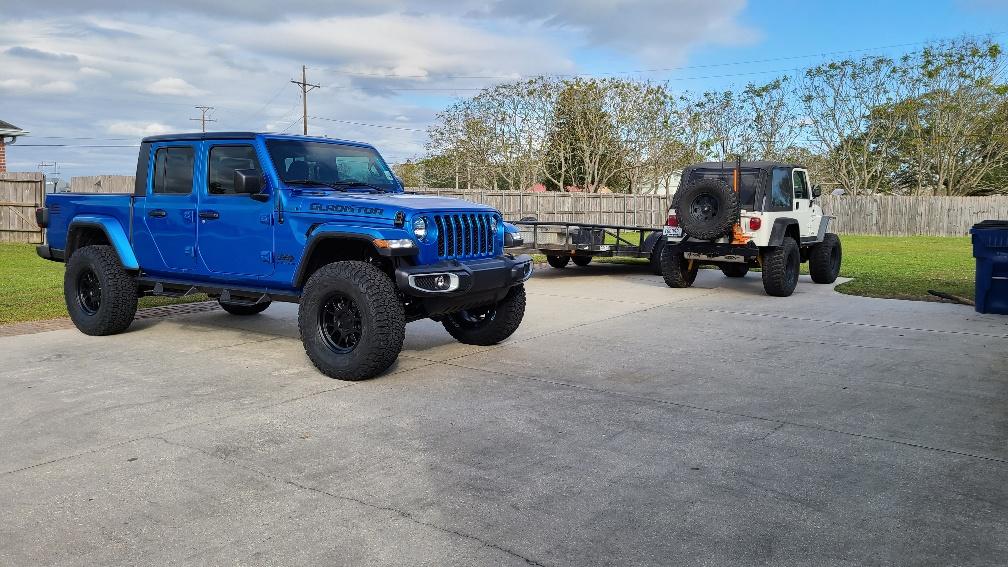 Jeep Gladiator Bruiser...hydro blue and black sport s diesel. front passenger corner shot