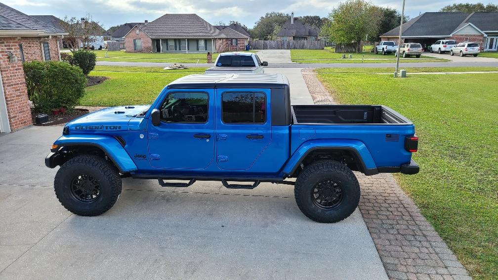 Jeep Gladiator Bruiser...hydro blue and black sport s diesel. outside driver from trailer