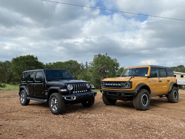 Jeep Gladiator I test drove the 2.3L 4 cylinder Bronco on Sunday 2021-jeep-wrangler-sahara-black-and-2021-ford-bronco-black-diamond-yellow_100797542_m