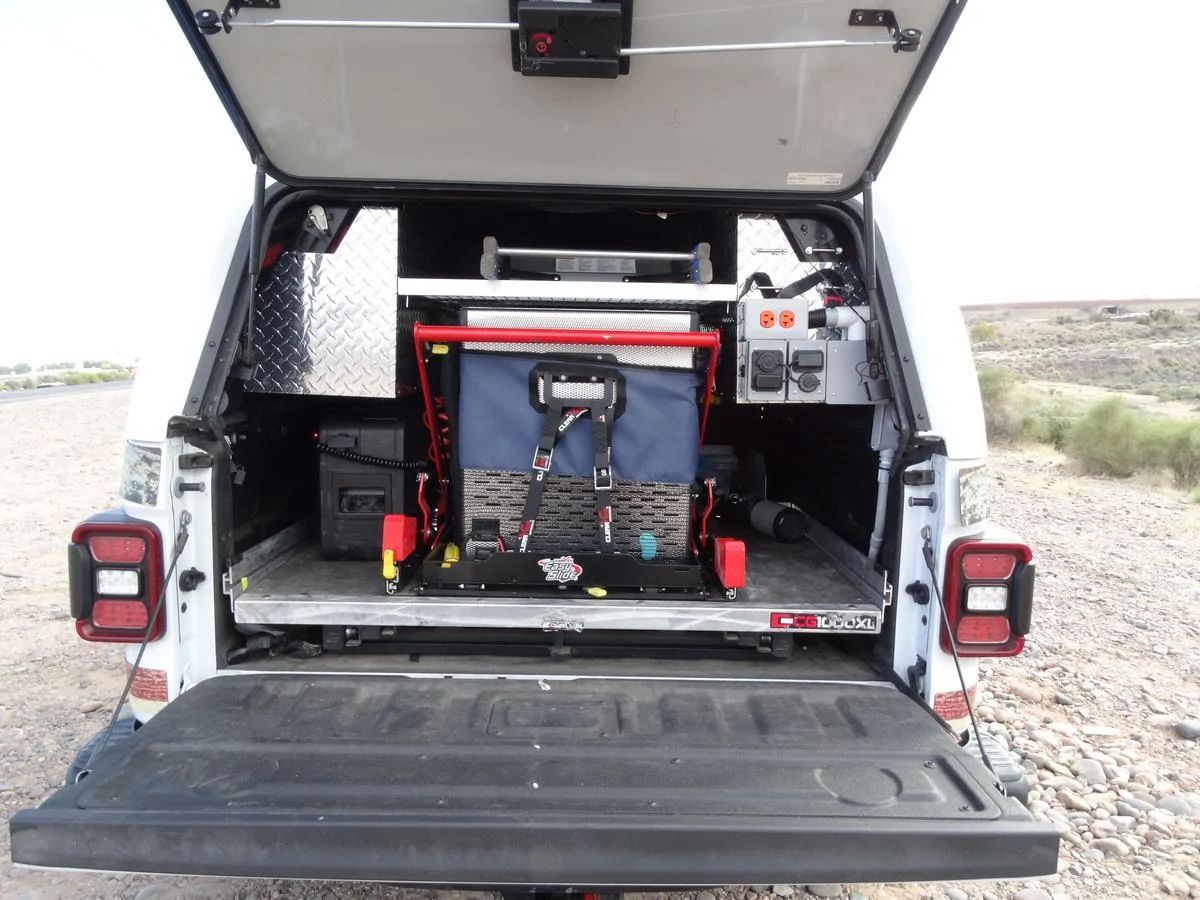 Jeep Gladiator A.R.E. CX EVOLVE CAP installed View inside the bet showing the CargoGlide slide,  National Luna fridge-freezer and custom el