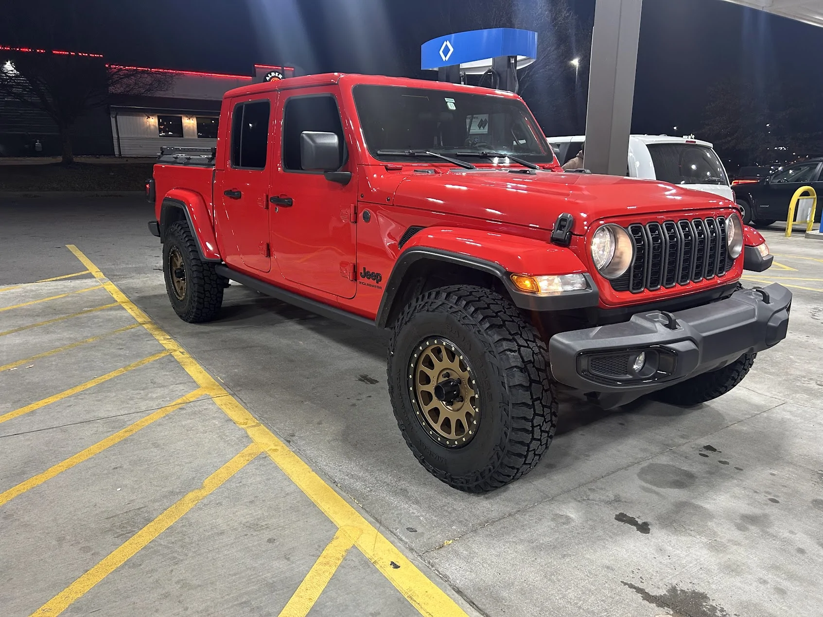 Jeep Gladiator Anyone go with more narrow 35” tires? Jeep Gladiator at Gas Station